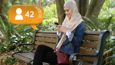 woman sitting on a park bench texting on her phone 4k