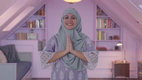 happy muslim woman doing namaste