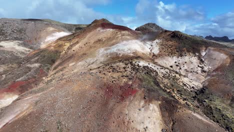 iceland's geothermal landscape, showcased in this photo, features steam rising from the ground, underscoring the country's volcanic origins