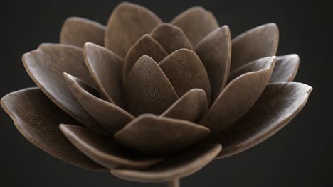 stunning macro view of a beautiful brown lotus flower sculpture highlighting intricate petal details and textures on a dark background