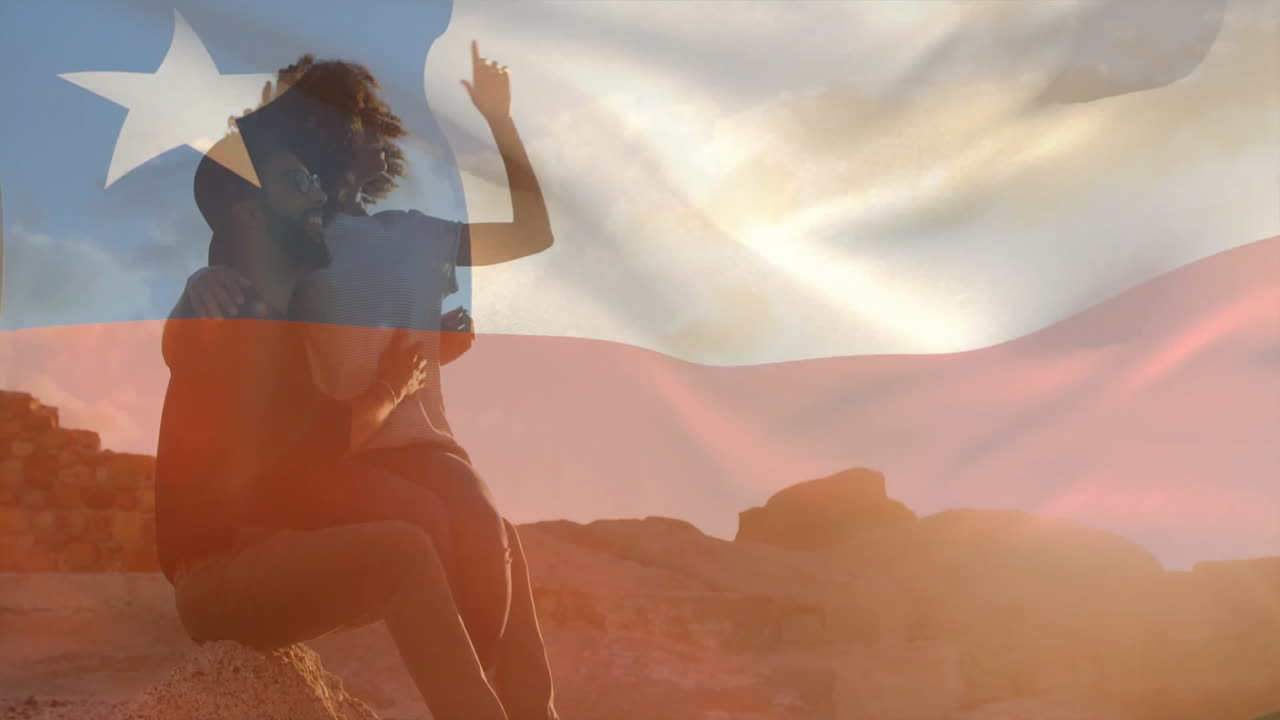 Sitting on rocks, person with Chilean flag animation in background outdoors