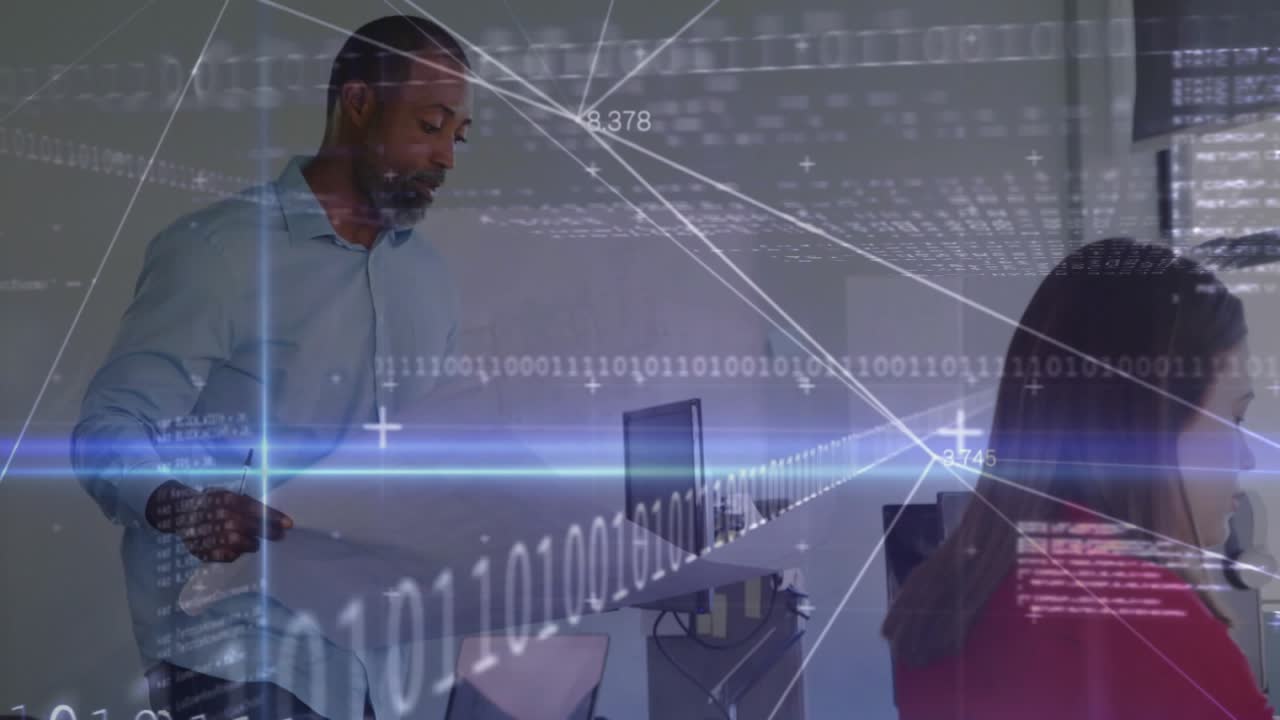Man unfolding blueprints beside colleague at desk, activating overlay explaining design details