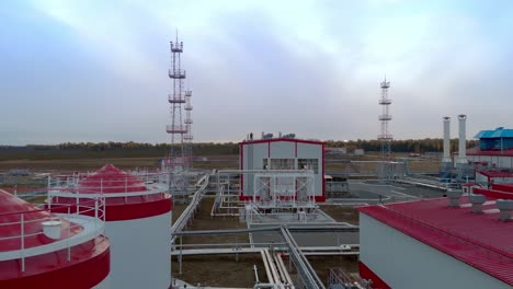 the drone flies over the industrial buildings of an oil refinery and a gas turbine station. flies over containers for storing emergency water for extinguishing a fire. dangerous job