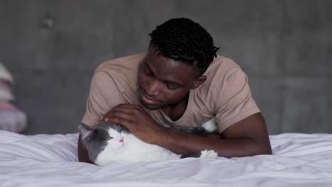 Pet-owner-with-his-cat-on-bed