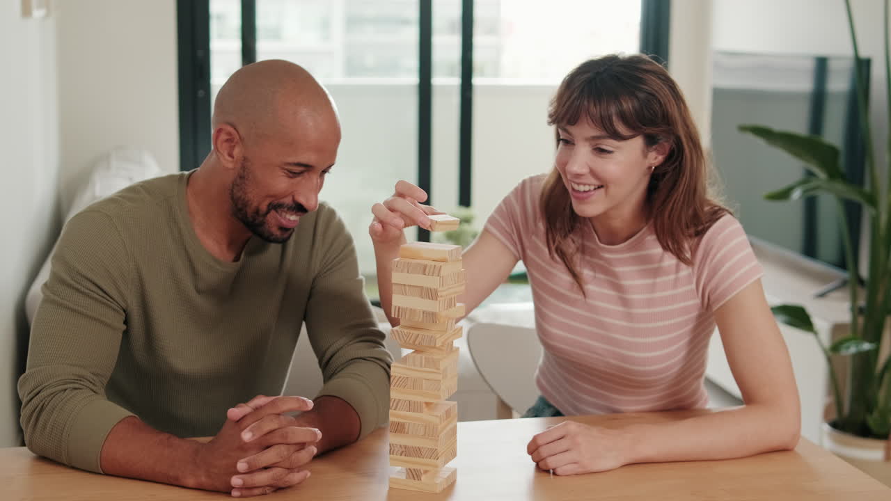 Couple Playing board games, playing Jenga at Home