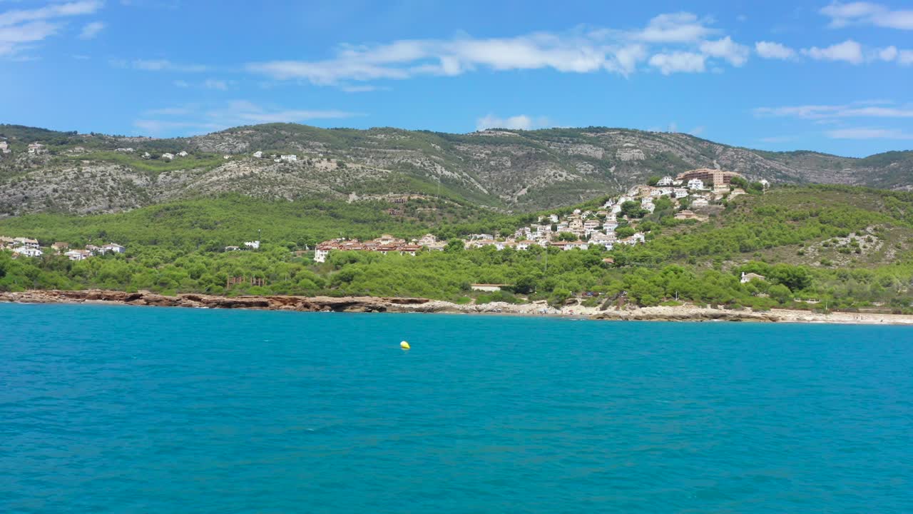 POV boat ride with speed boat on beautiful blue sea alongside Alcossebre Valencian Community coastline in Spain, Europe