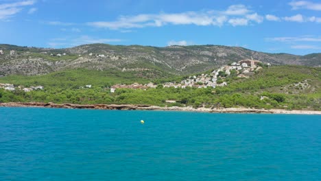 POV-boat-ride-with-speed-boat-on-beautiful-blue-sea-alongside-Alcossebre-Valencian-Community-coastline-in-Spain,-Europe