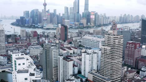 aerial: amazing shanghai central business district, zoom reveal from downtown