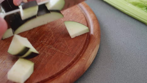 Close-up-of-chopping-an-aubergine--into-cubes