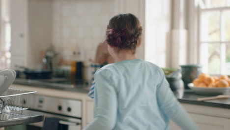 happy teenage girl dancing in kitchen having fun weekend celebrating at home with funny dance moves enjoying playful freedom