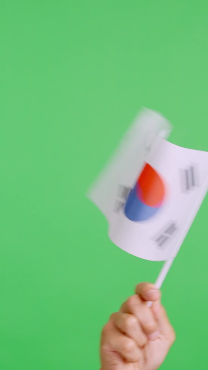 Hand waving a pennant of a south korean national flag