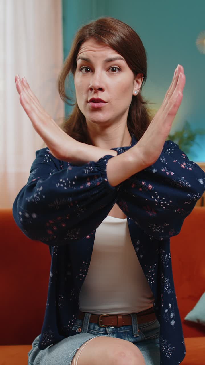 Woman says no hold palm folded crossed hands warning of finish prohibited access stop gesture