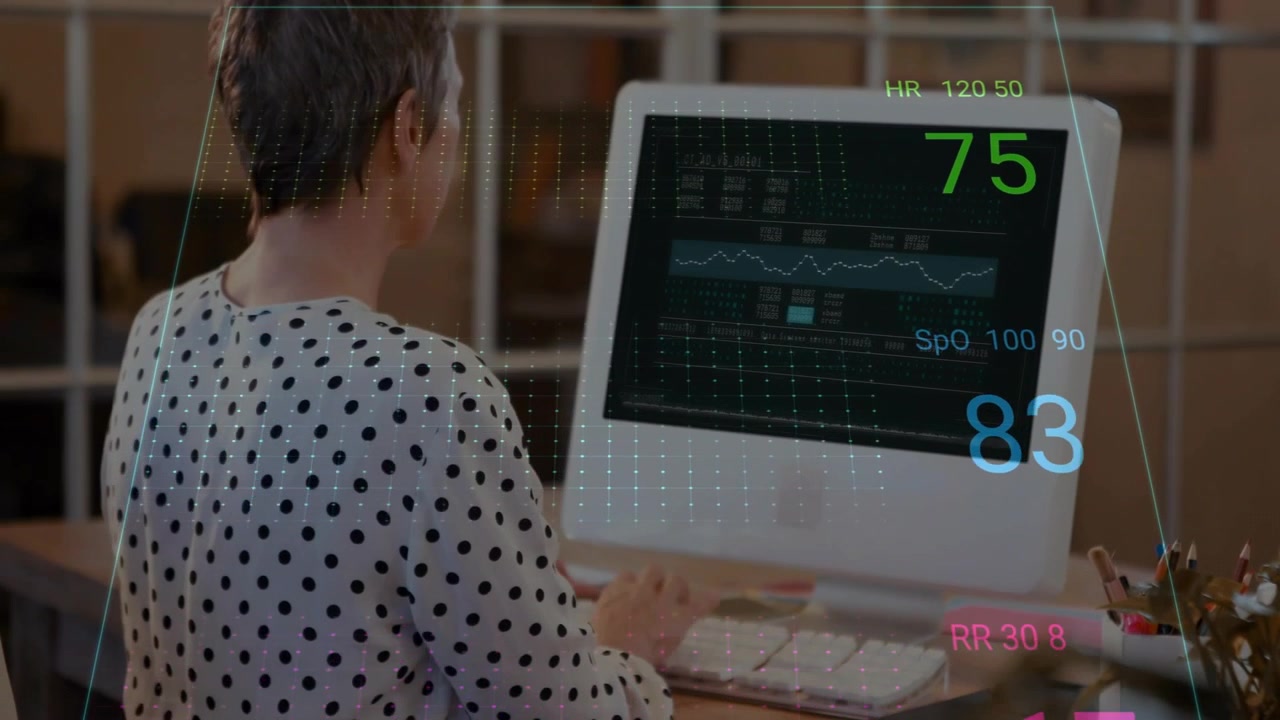 Adult woman typing on keyboard, HUD appearing, checking ECG vitals on monitor while analyzing data