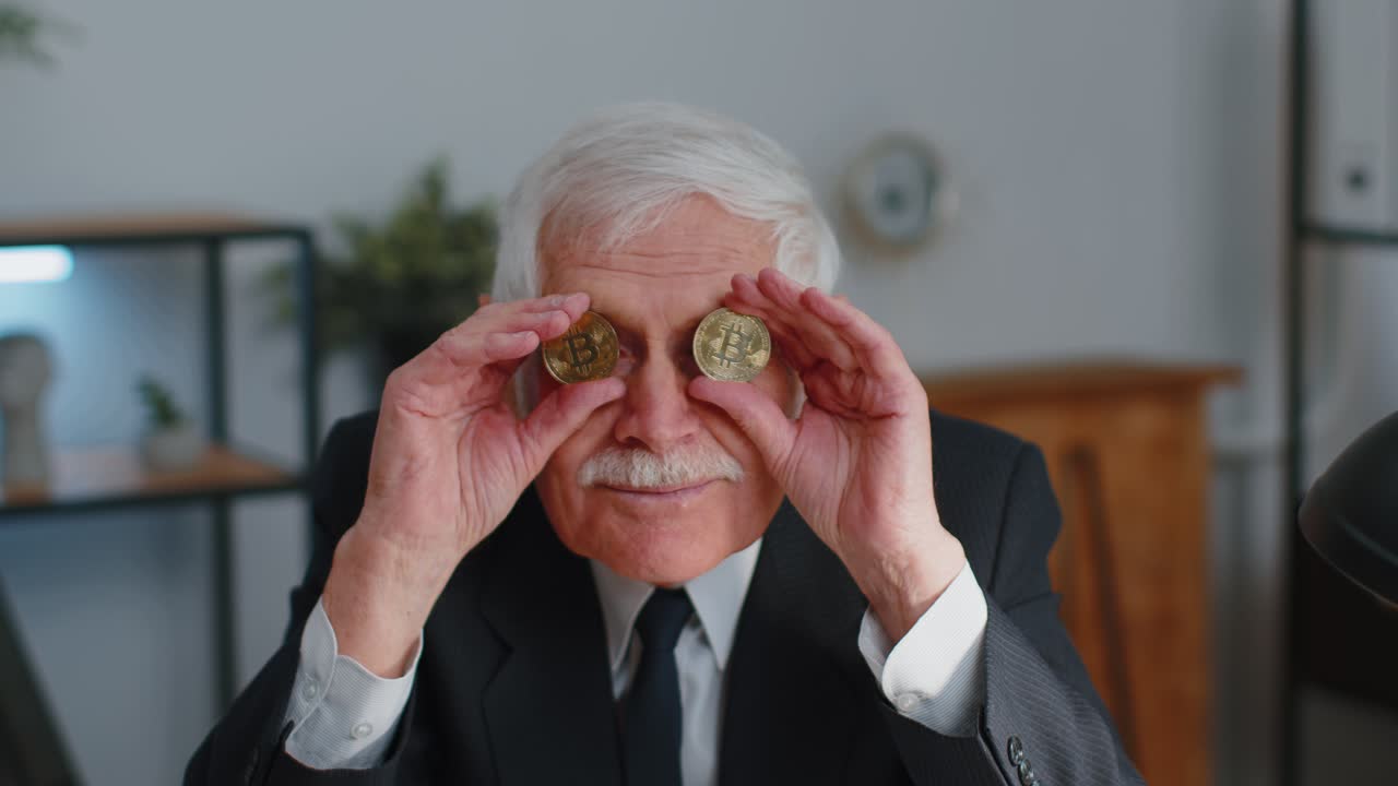 Elderly businessman showing golden bitcoins btc money mining investment wealth earning income