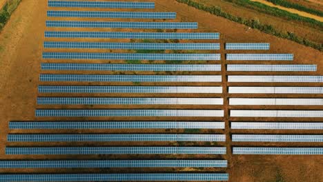 solar panels photovoltaics in solar farm. aerial video footage, view of solar panels at a renewable energy energy of the future generation farm at sunset in lincolnshire, uk