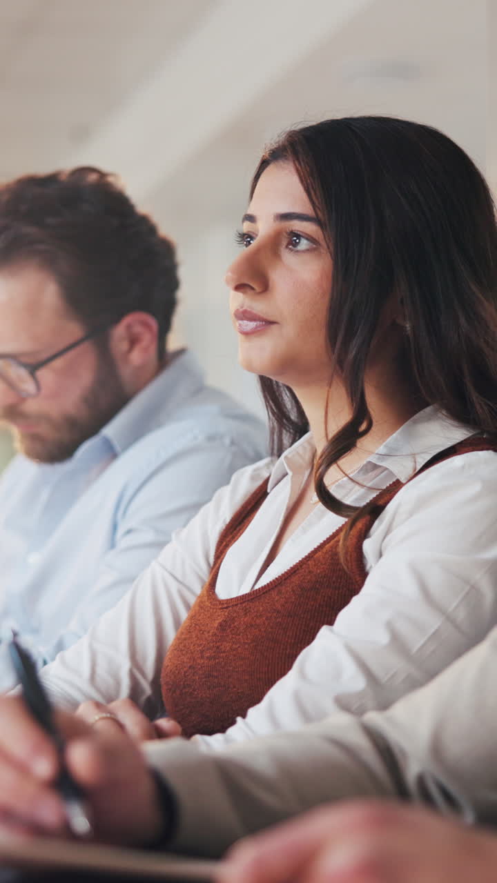 Young Woman Attending a Business Meeting and Asking a Question