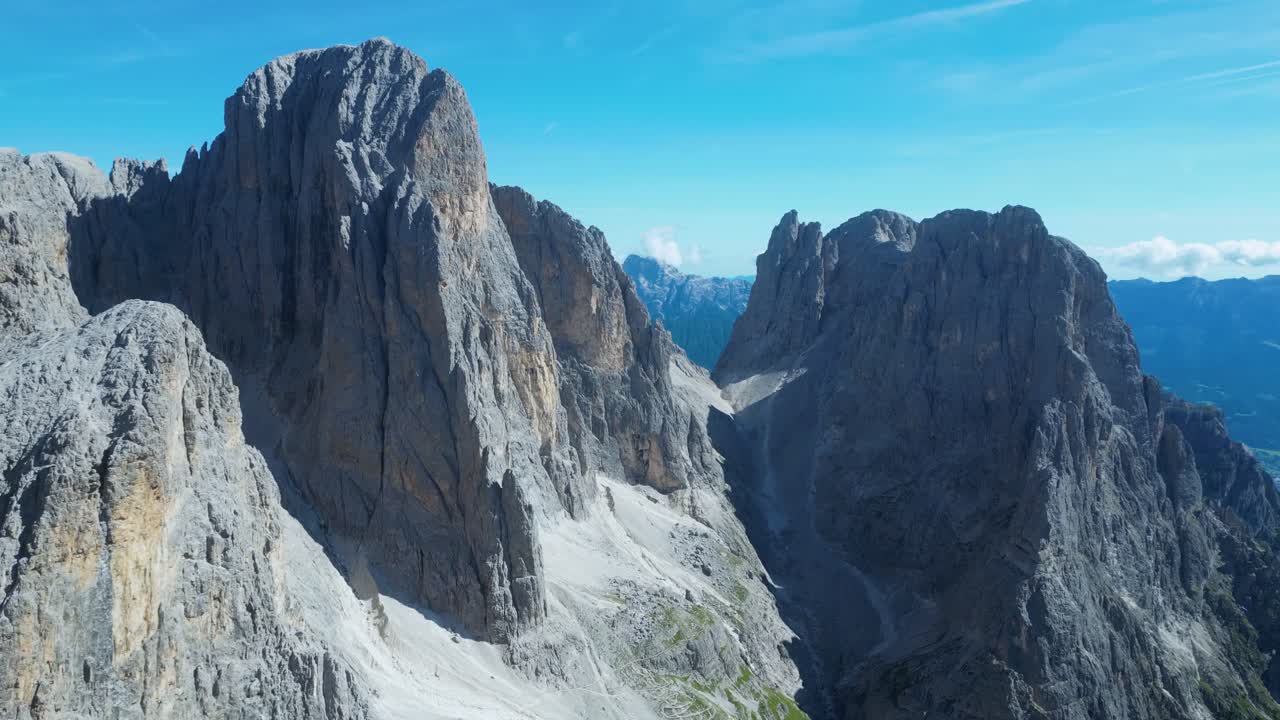 Drone footage of the Pale di San Martino in the Dolomites, Italy: majestic peaks, rocky spires, alpine meadows, and dramatic landscapes ideal for travel, nature, and adventure projects