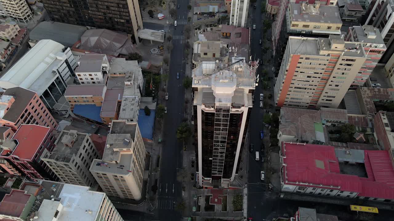 Straight-down aerial of building blocks in La Paz, Bolivia with dramatic mid-city symmetry and light
