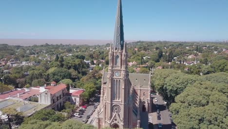 aerial view of the cathedral surrounded by green trees and the river in the background - buenos aires - san isidro