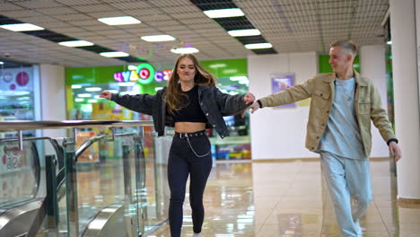 Couple running in a mall