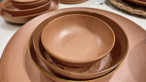 stacked ceramic bowls and plates in earthy tones