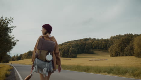 young female explorer walking on road against sky