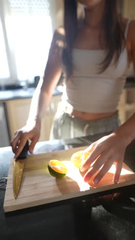 woman preparing fruit in kitchen