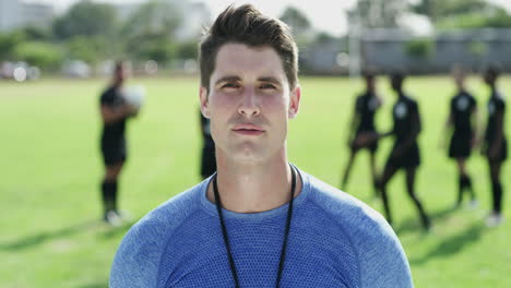 a rugby coach standing on a field with his team