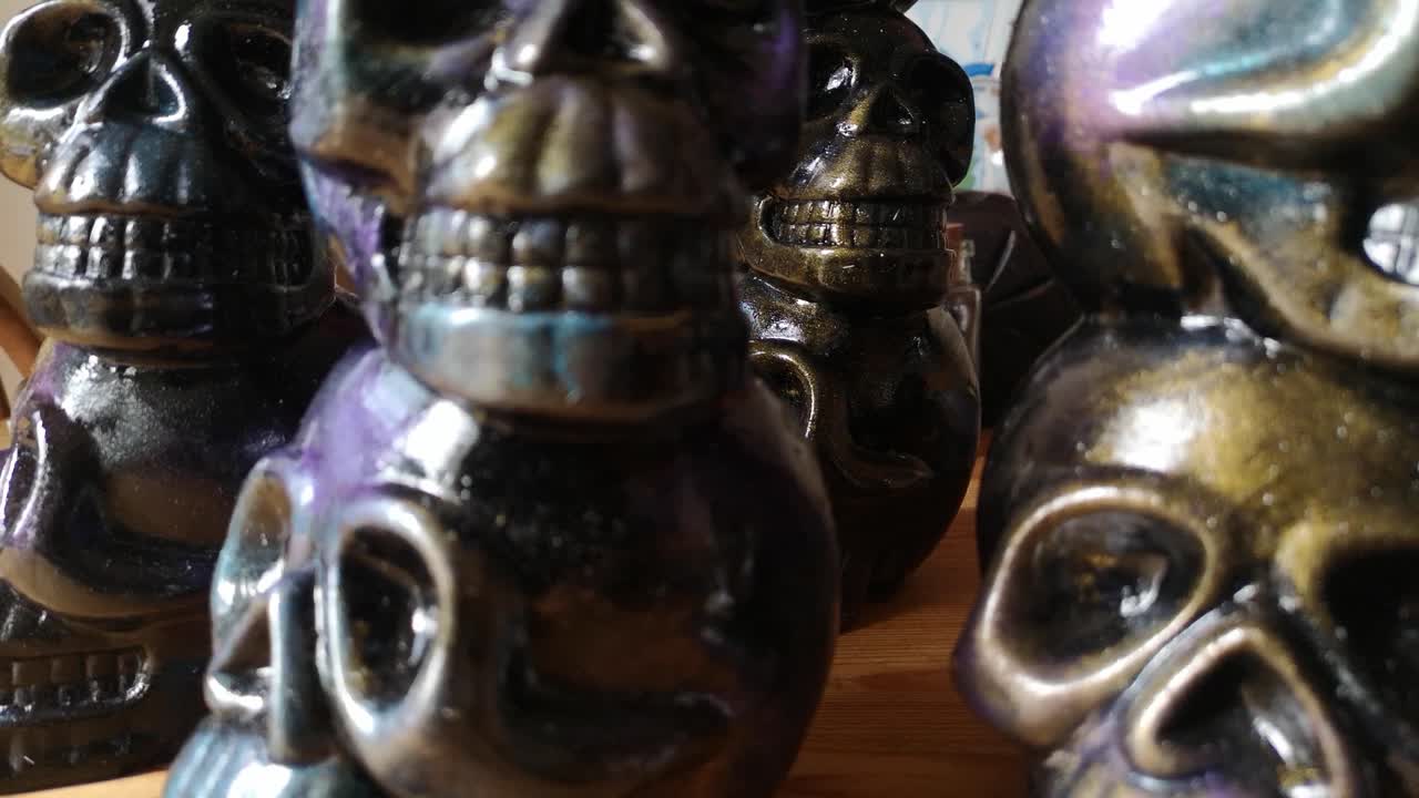 Multicoloured painted ceramic spooky death skull totem crafts pottery ornament dolly left closeup