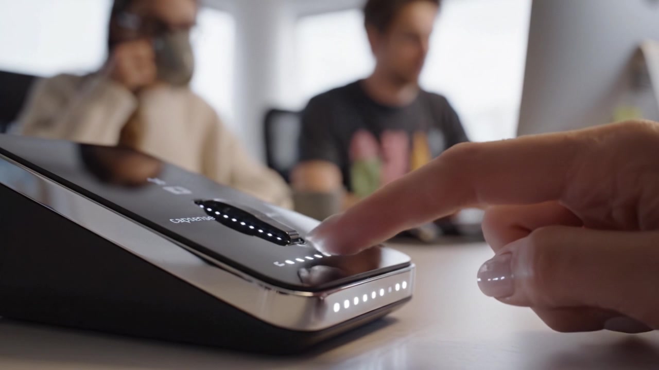 Innovative Technology in Action: Close-Up of User Interacting with a Modern Device in a Collaborative Workspace Environment, Showcasing User Experience and Design