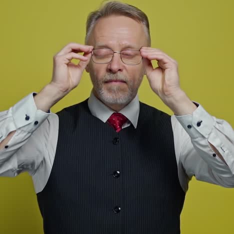 funny grey-haired man with glasses. portrait of a mature man in suit putting on glasses with a funny view. slow motion. positive emotions.