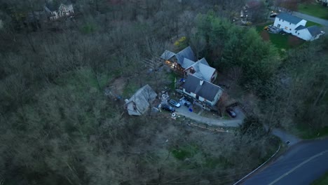 top down aerial orbit of cabin in woods at night