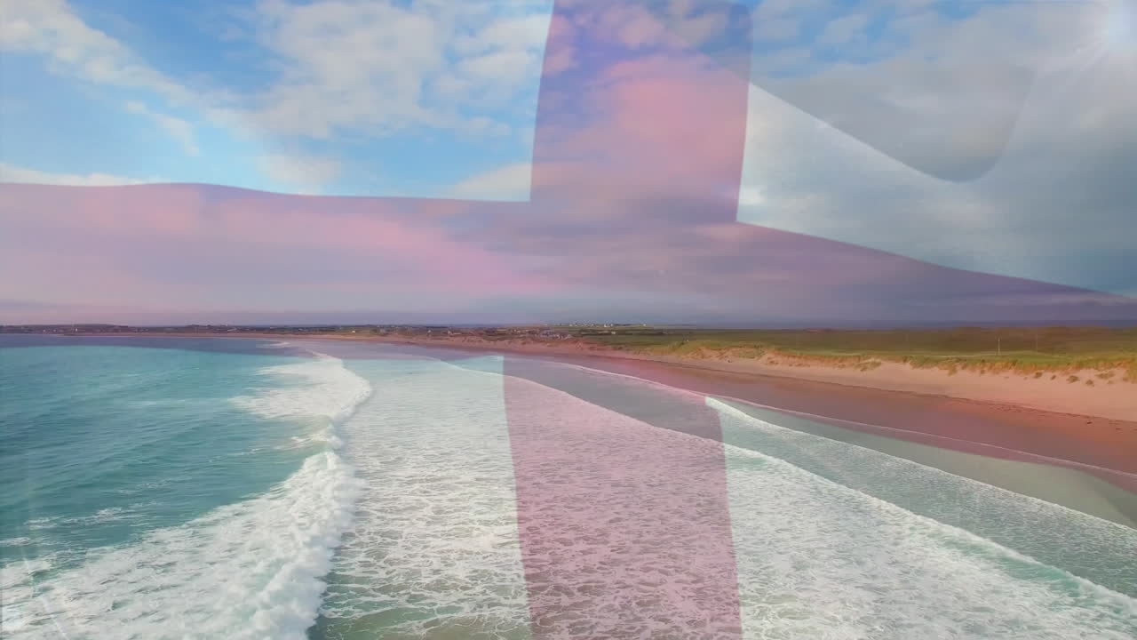 composición digital de la bandera de inglaterra ondeando contra la vista aérea de la playa