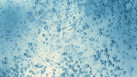 many water bubbles in blue water close up, abstract water wave with bubbles in slow motion.