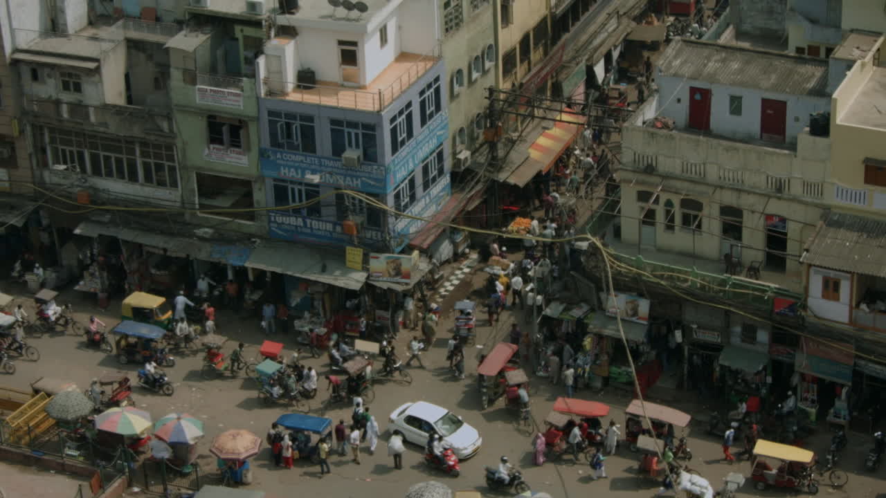 A busy city street is filled with people and vehicles