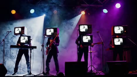 band with tv heads on stage