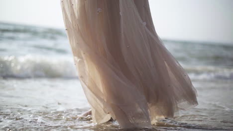 slow motion.women walking barefoot by the beach while the sun sets.waves at sunset.