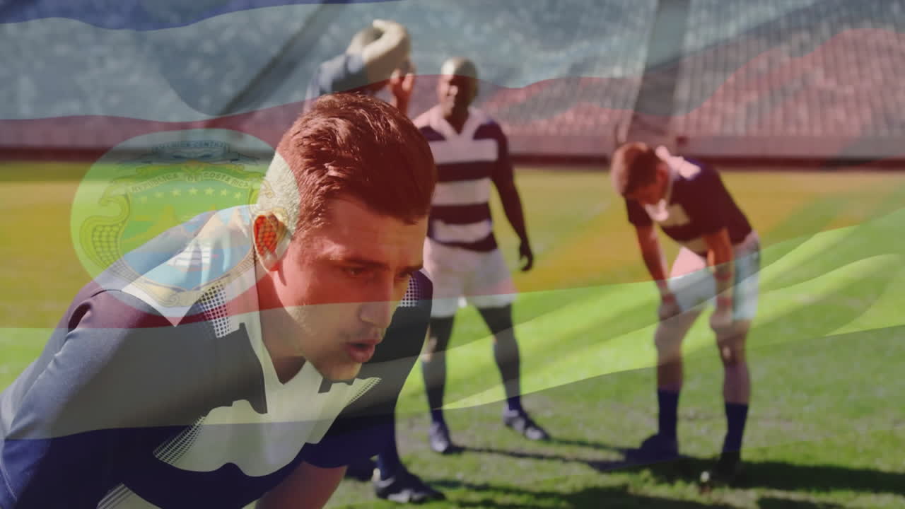 Resting on field, rugby players with Costa Rican flag animation overlay