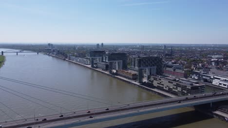 crane house buildings on cologne city riverfront and severin bridge traffic