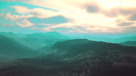 stunning mountain range with clouds at sunset