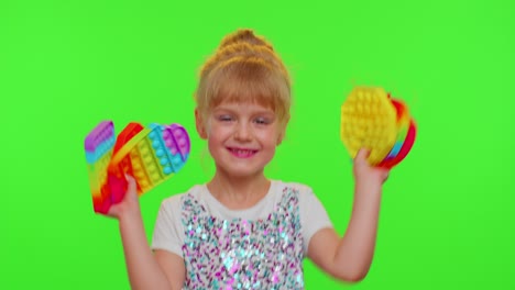 Child-girl-kid-holding-many-colorful-squishy-silicone-bubbles-sensory-toy,-kid-playing-pop-it-game