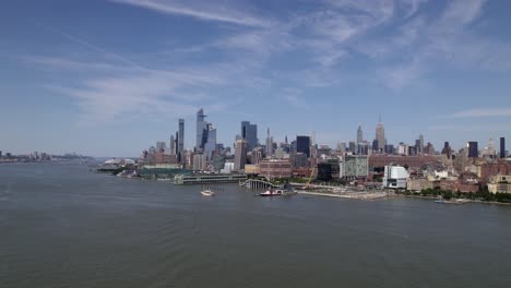 Aerial-view-over-the-river,-towards-the-FDNY-Marine-1,-in-sunny-New-York,-USA