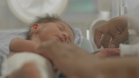 close up of newborn in incubator