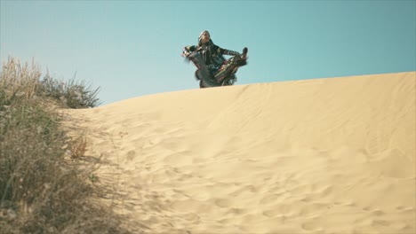 Gypsy-woman-walking-and-waving-her-dress-on-a-desert-sand-dune