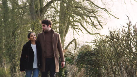 loving young couple walking through winter countryside together