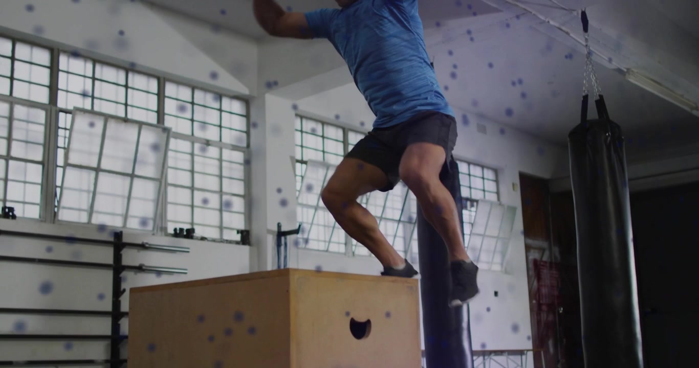 Man shifting weight, jumping onto plyo box for fitness, landing, dotted trail marking jump path
