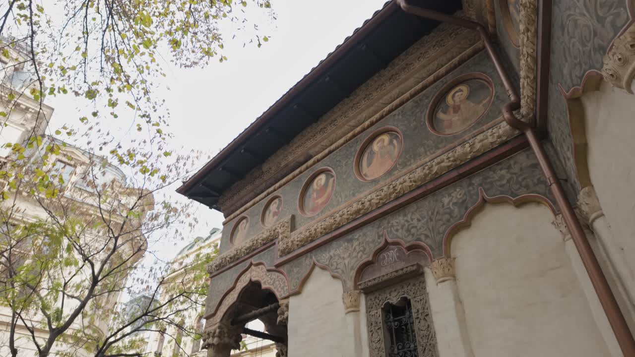 Ornate frescoed exterior of Stavropoleos Monastery in Bucharest old town