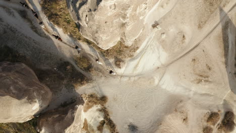 Topdown-Shot-Of-Tourist's-Horse-Trekking-Through-Cappadocia-Landscapes-In-Turkey