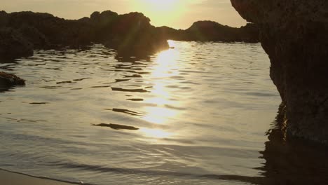 golden hour sun reflecting on ripples of mediterranean sea in cyprus