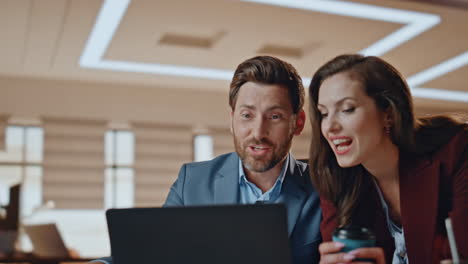 closeup woman bringing coffee colleague working office. happy coworkers talking